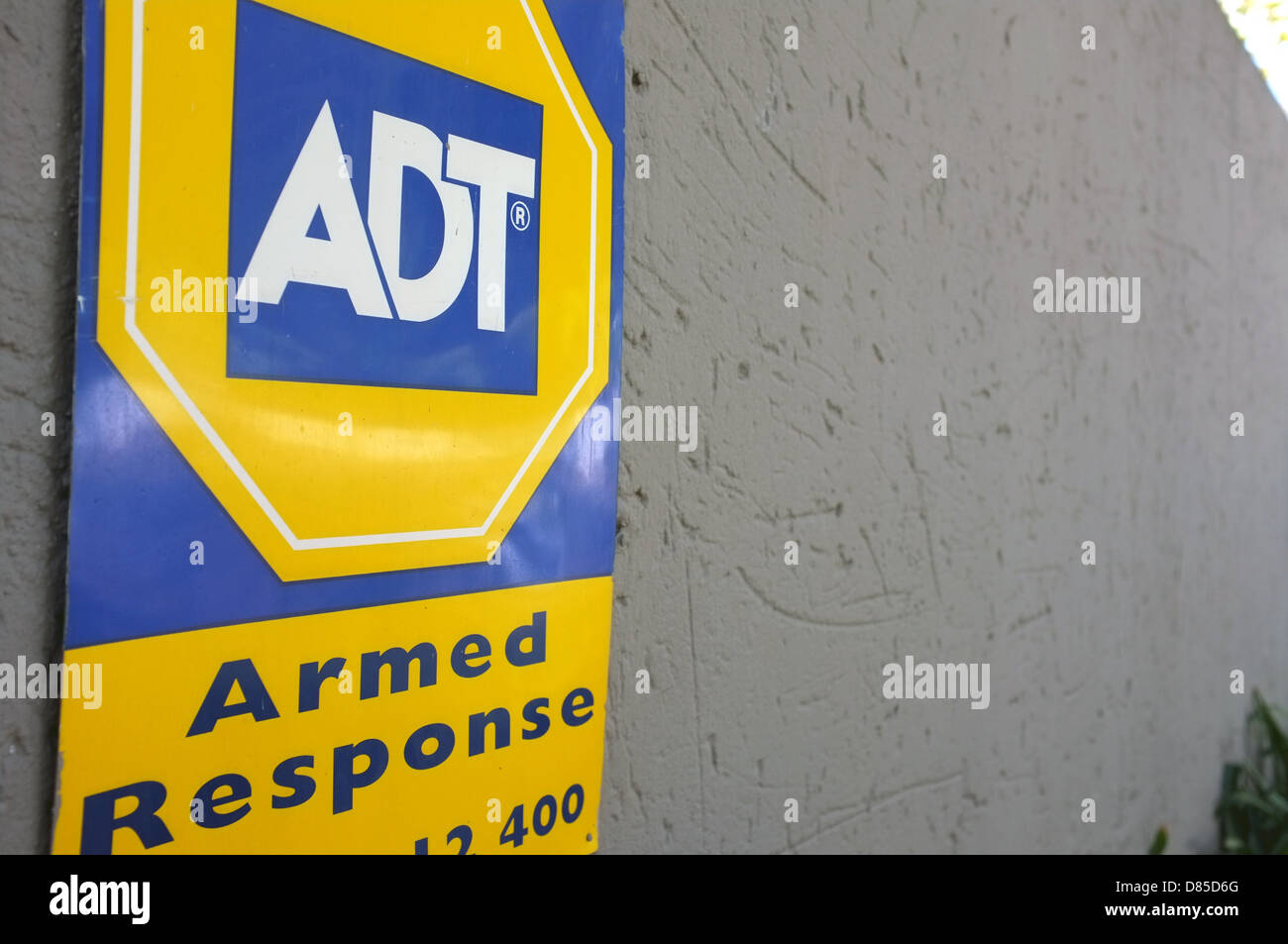 An armed response security sign on the side of a building in the suburbs of Johannesburg, South Africa. Stock Photo