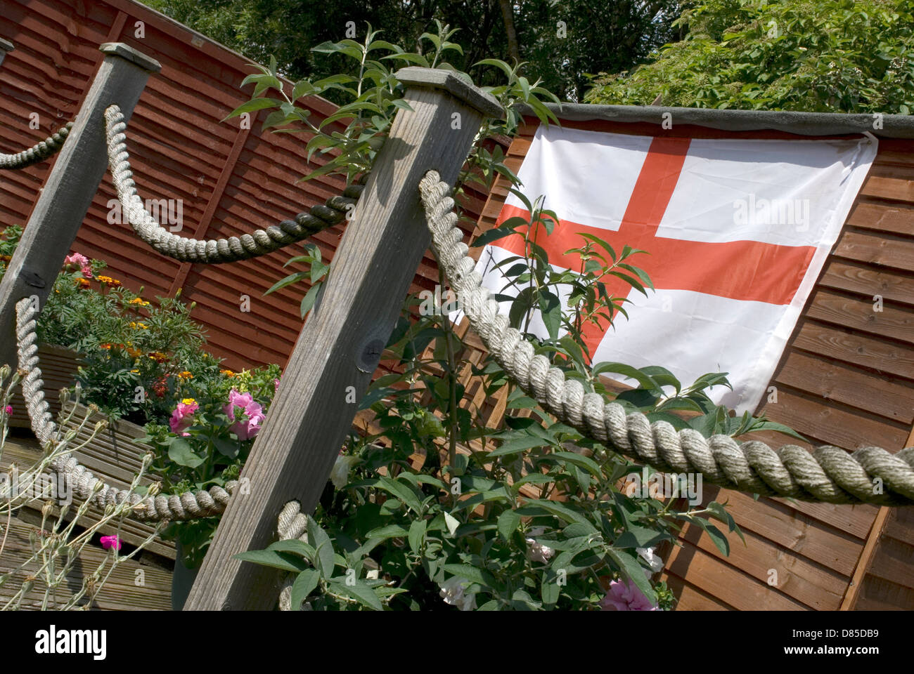 Garden decking posts in spring with rope loops and st flag on