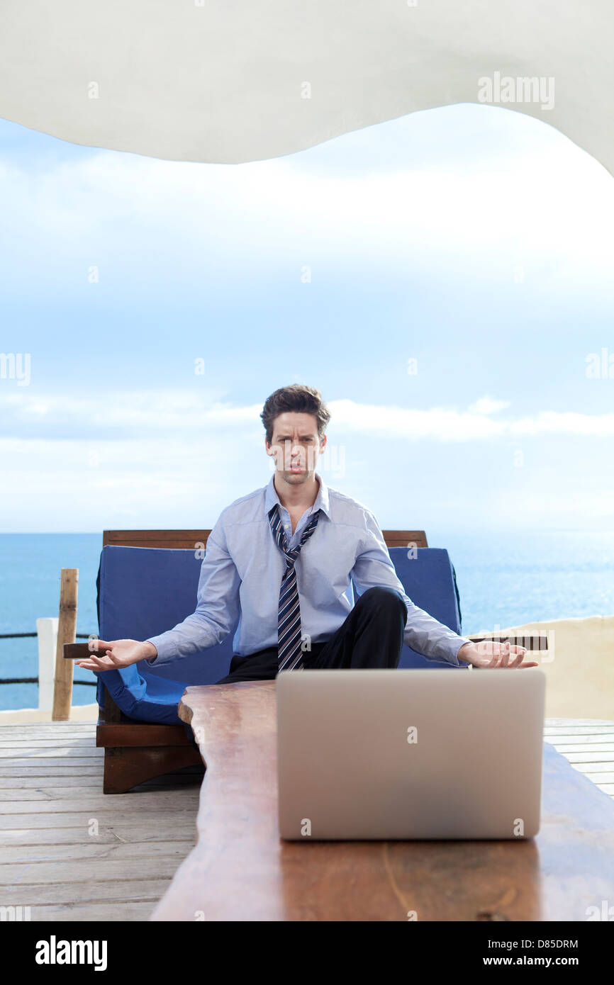 businessman sitting on soflooking laptop. Stock Photo