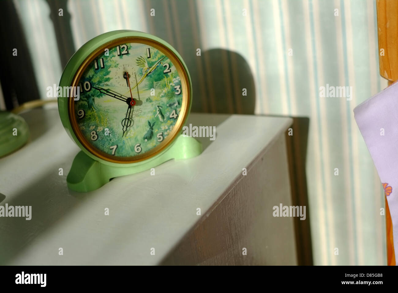 A vintage Smith Sectric alarm clock in the early morning sun. Stock Photo