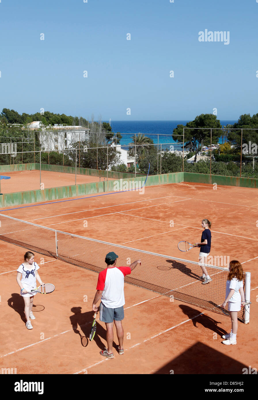 Tennis instructor teaching children how to play, Paguera,Mallorca,Spain