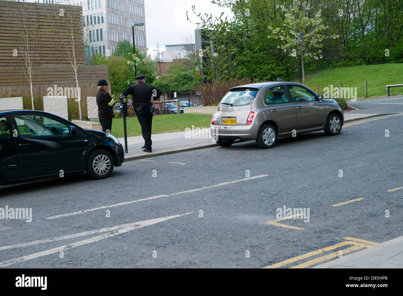 Traffic Wardens waiting to issue parking ticket Stock Photo Alamy