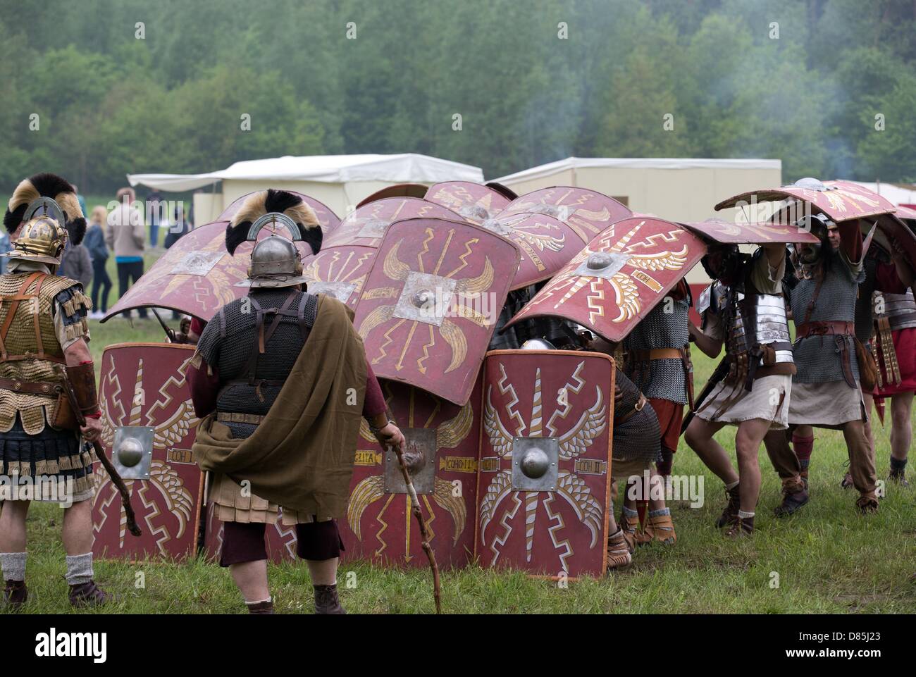 Performers in Roman uniforms present a so-called tortoise-formation at The Battle of the Teutoburg Museum in Bramsche, Germany, 20 May 2013. The everyday life of Romans and the Germanic people is depicted at Museum Park Kalkriese during the Romans and Germanic people days. Photo: Friso Gentsch Stock Photo