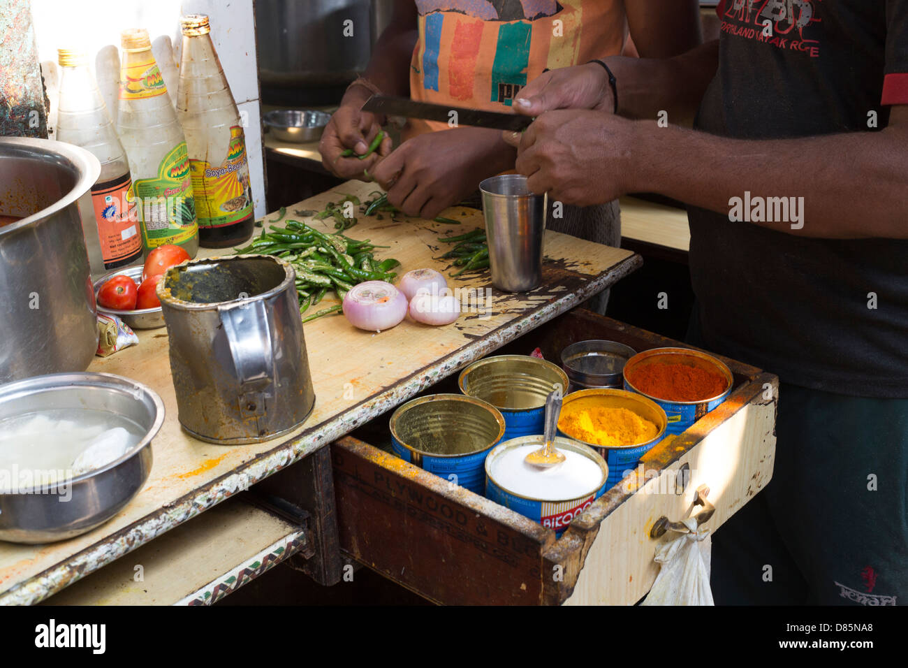 India, Uttar Pradesh, New Delhi, back street scene near New Delhi Railway Station of men preparing vegetables Stock Photo
