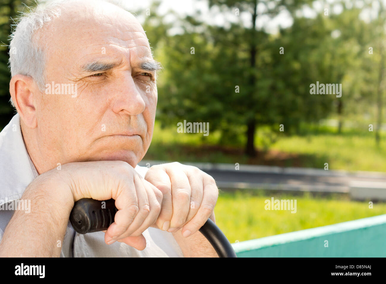 Senior bald man looking at something in a park Stock Photo