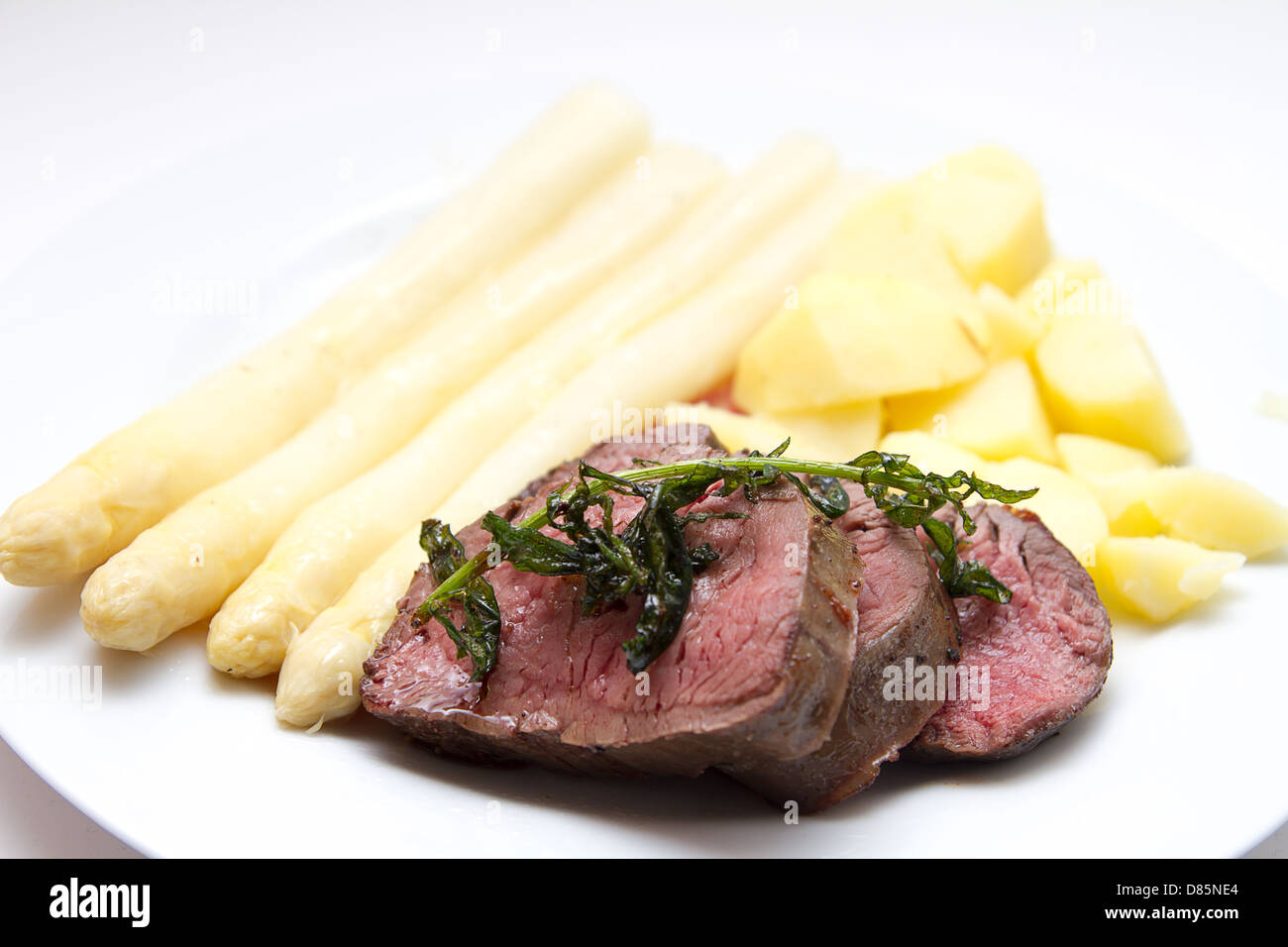 beef fillet with white asparagus and potatoes Stock Photo
