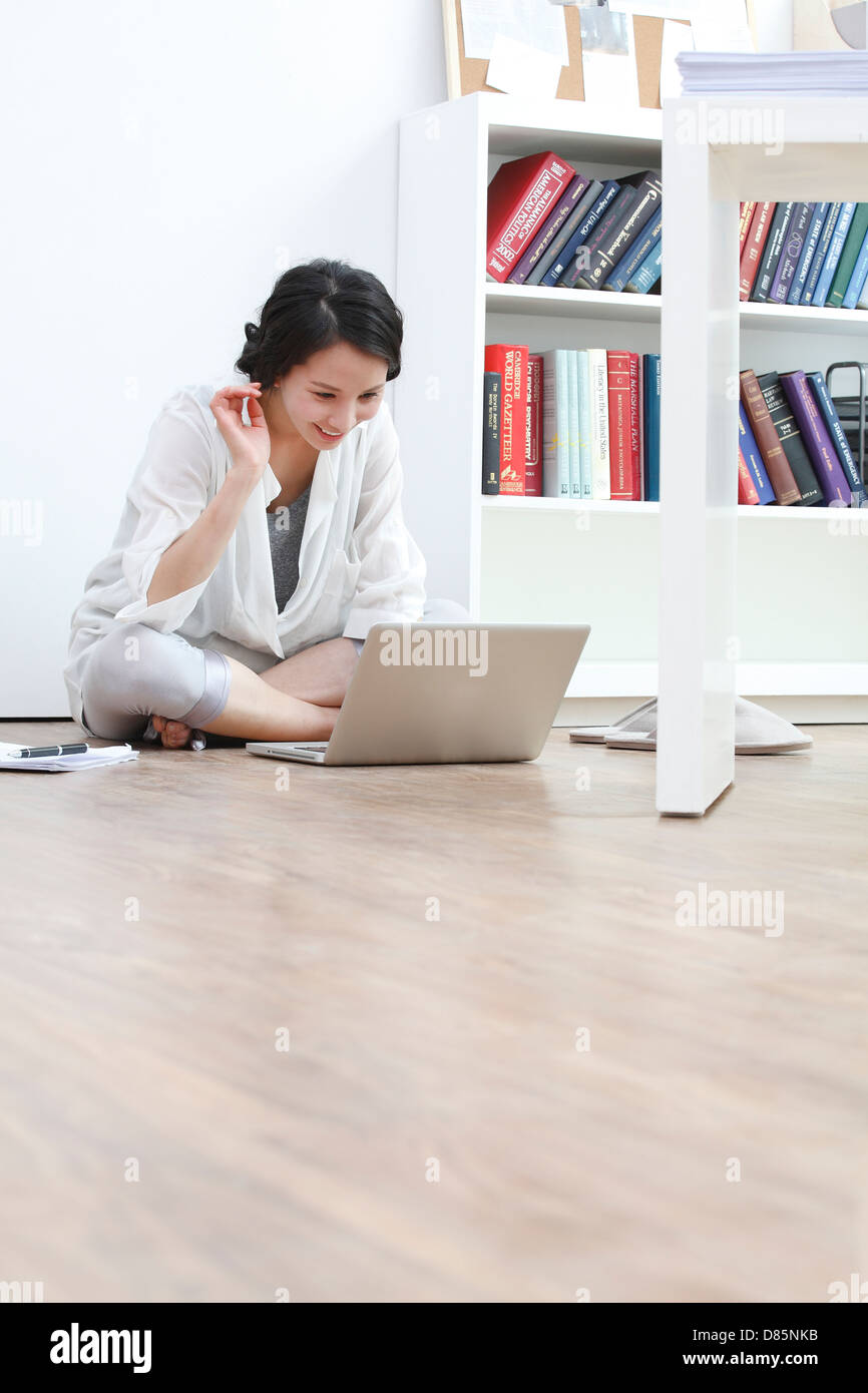 young woman sitting on floor laptop computer Stock Photo - Alamy