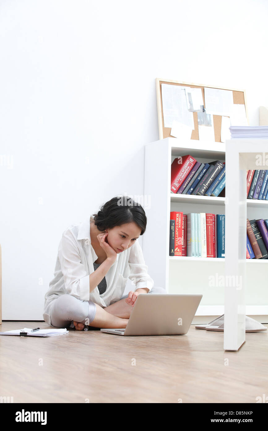 young woman sitting on floor laptop computer Stock Photo - Alamy