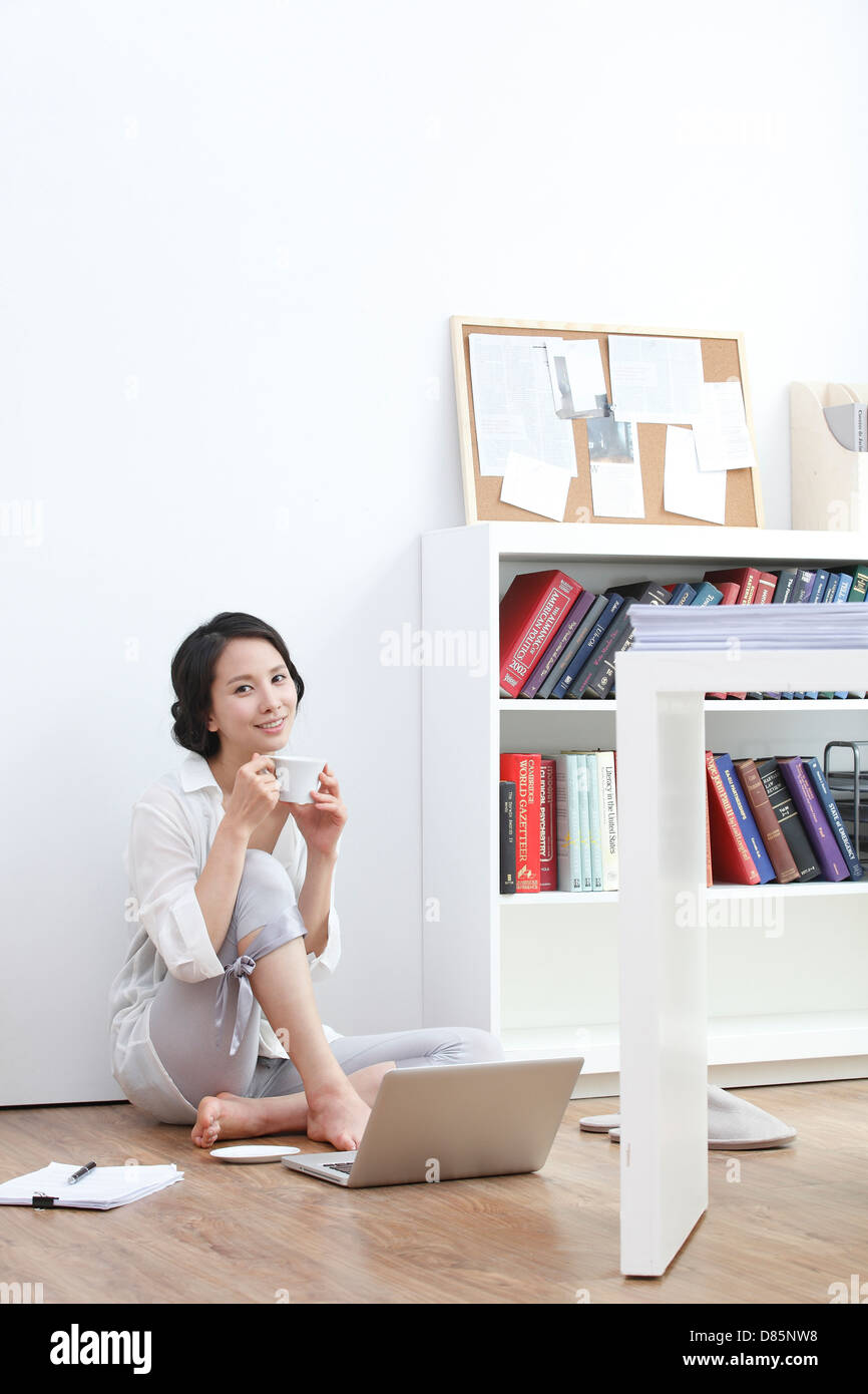 young woman sitting on floor laptop computer Stock Photo - Alamy