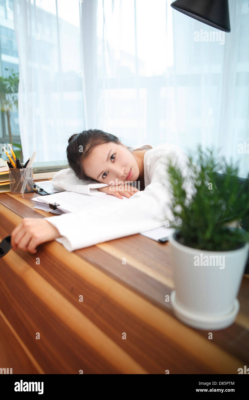 young woman sitting desk Stock Photo - Alamy
