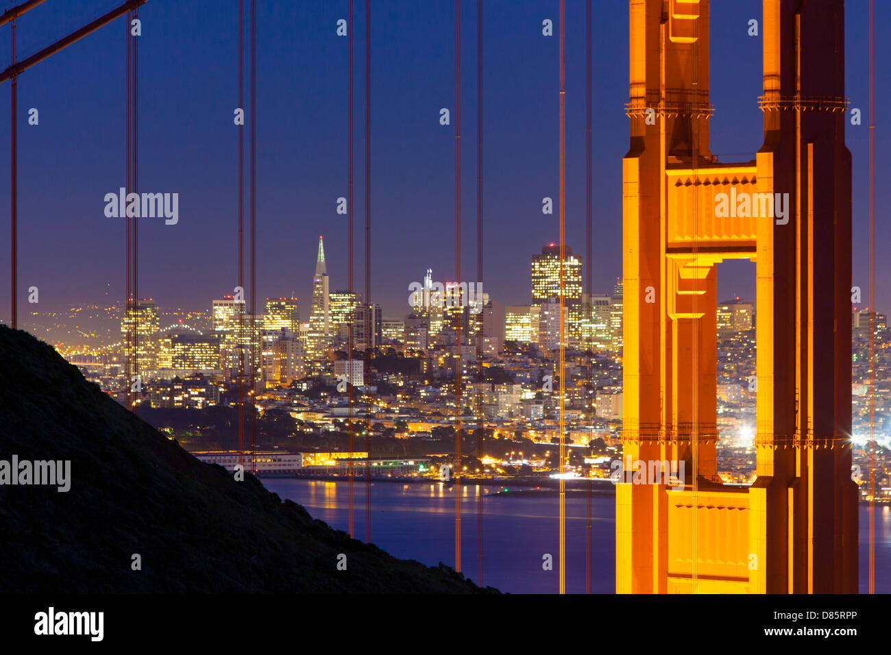 A view at dusk thru the Golden Gate Bridge towards downtown San Francisco. IN California, USA. Stock Photo