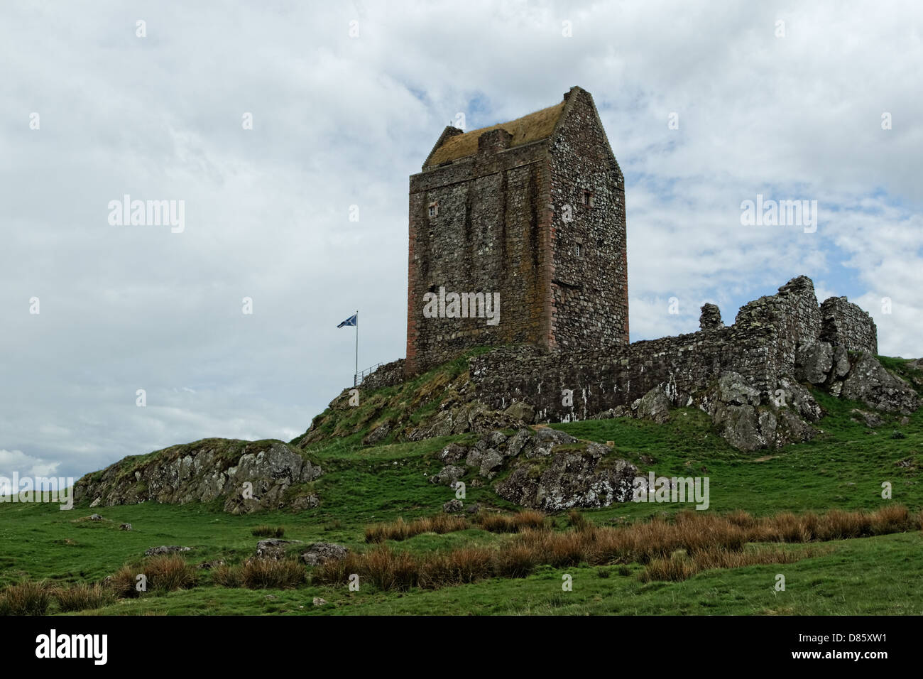 Smailholm Tower 1450 atop crag with Scottish national flag Stock Photo