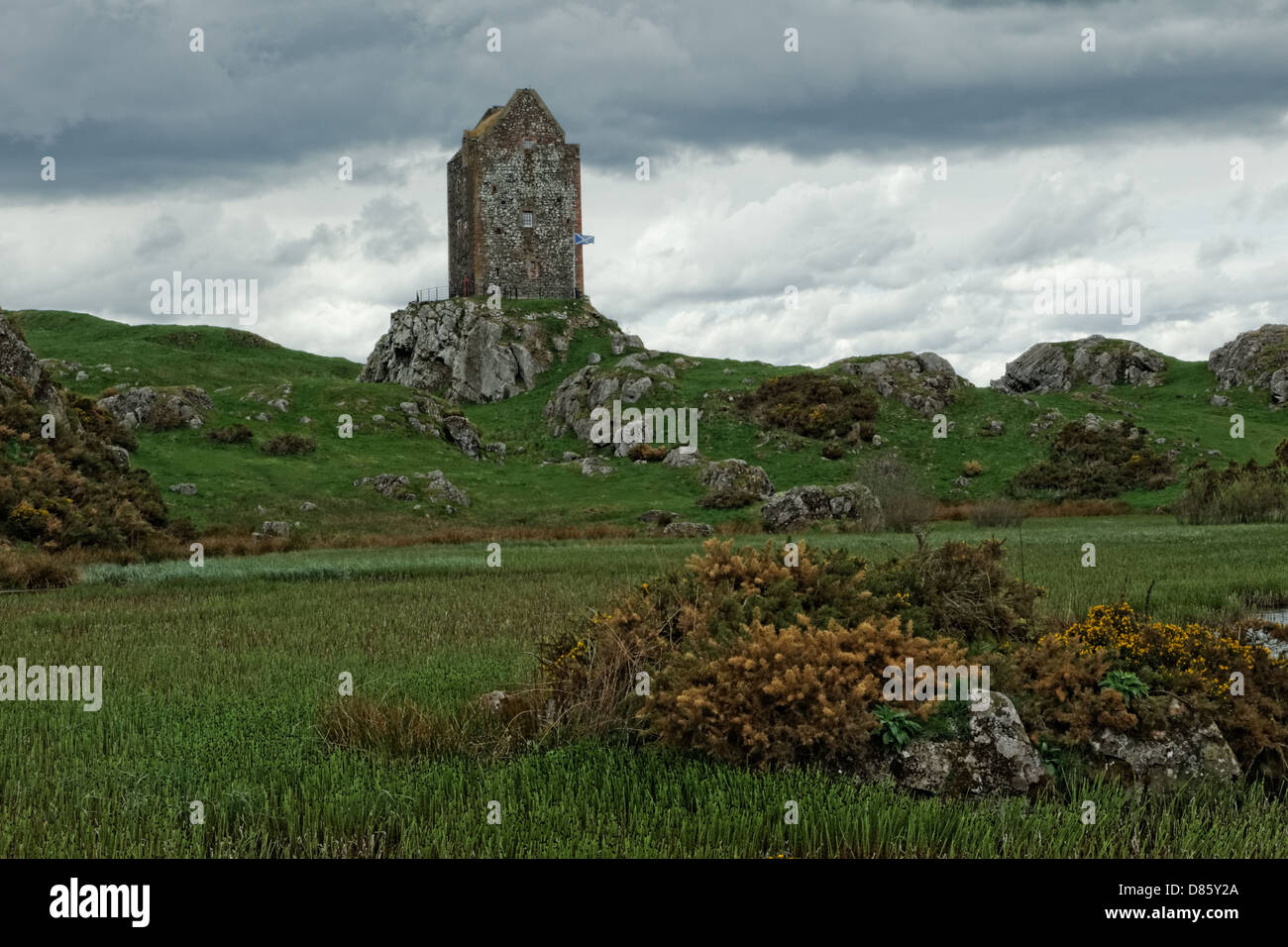 Smailholm Tower 1450 across lochan with Scottish flag Stock Photo