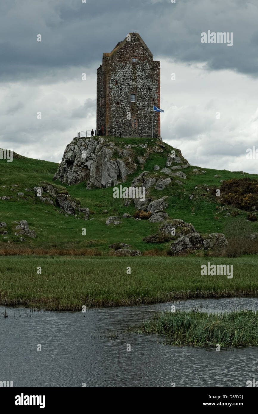 Smailholm Tower 1450 across lochan with Scottish flag Stock Photo