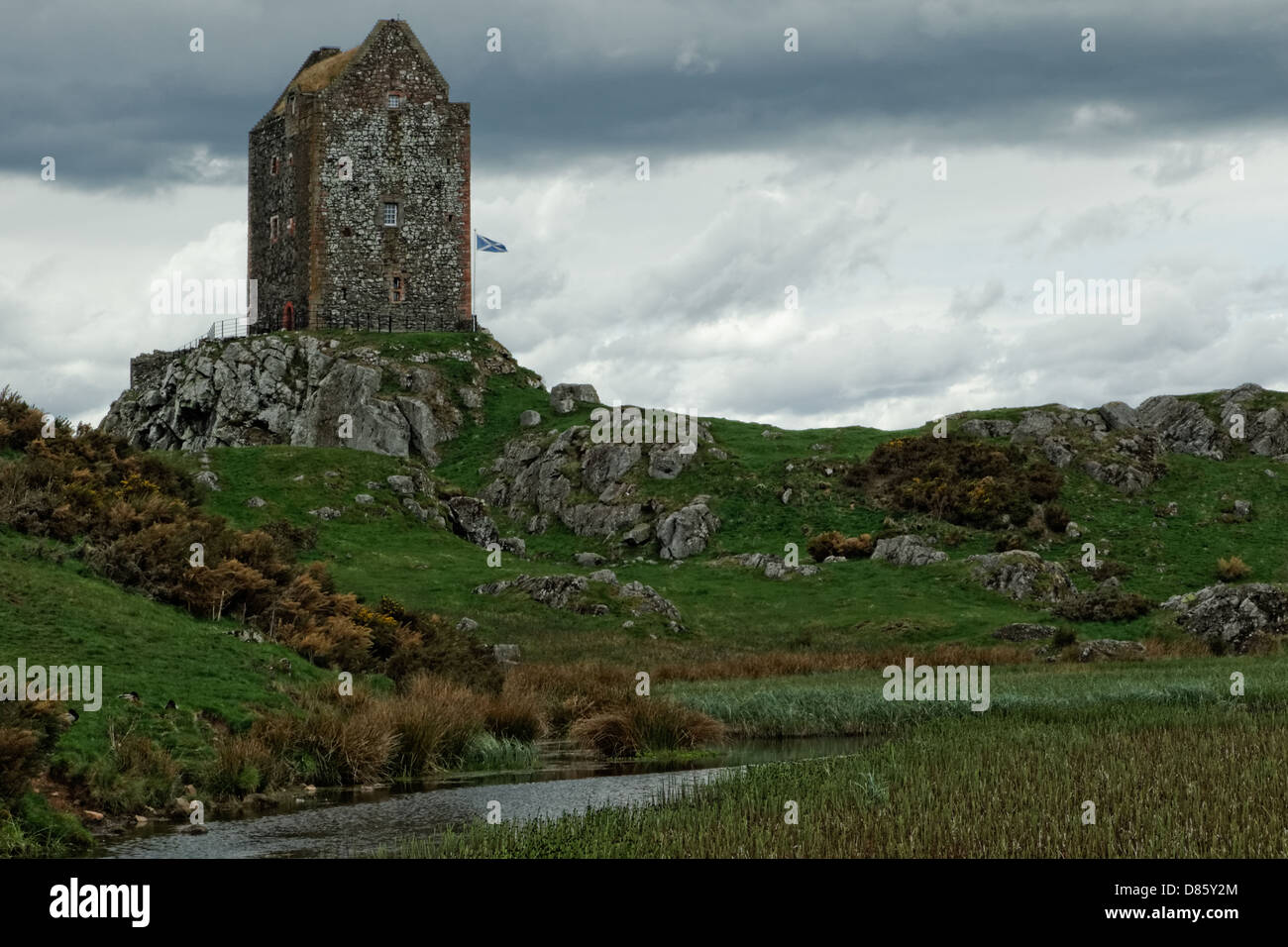 Smailholm Tower 1450across lochan with Scottish flag Stock Photo