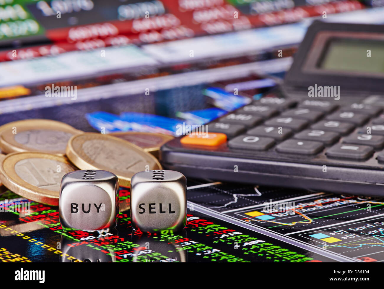 Dices cubes with words SELL BUY for trader, euro coins and calculator. Financial chart as background. Selective focus Stock Photo