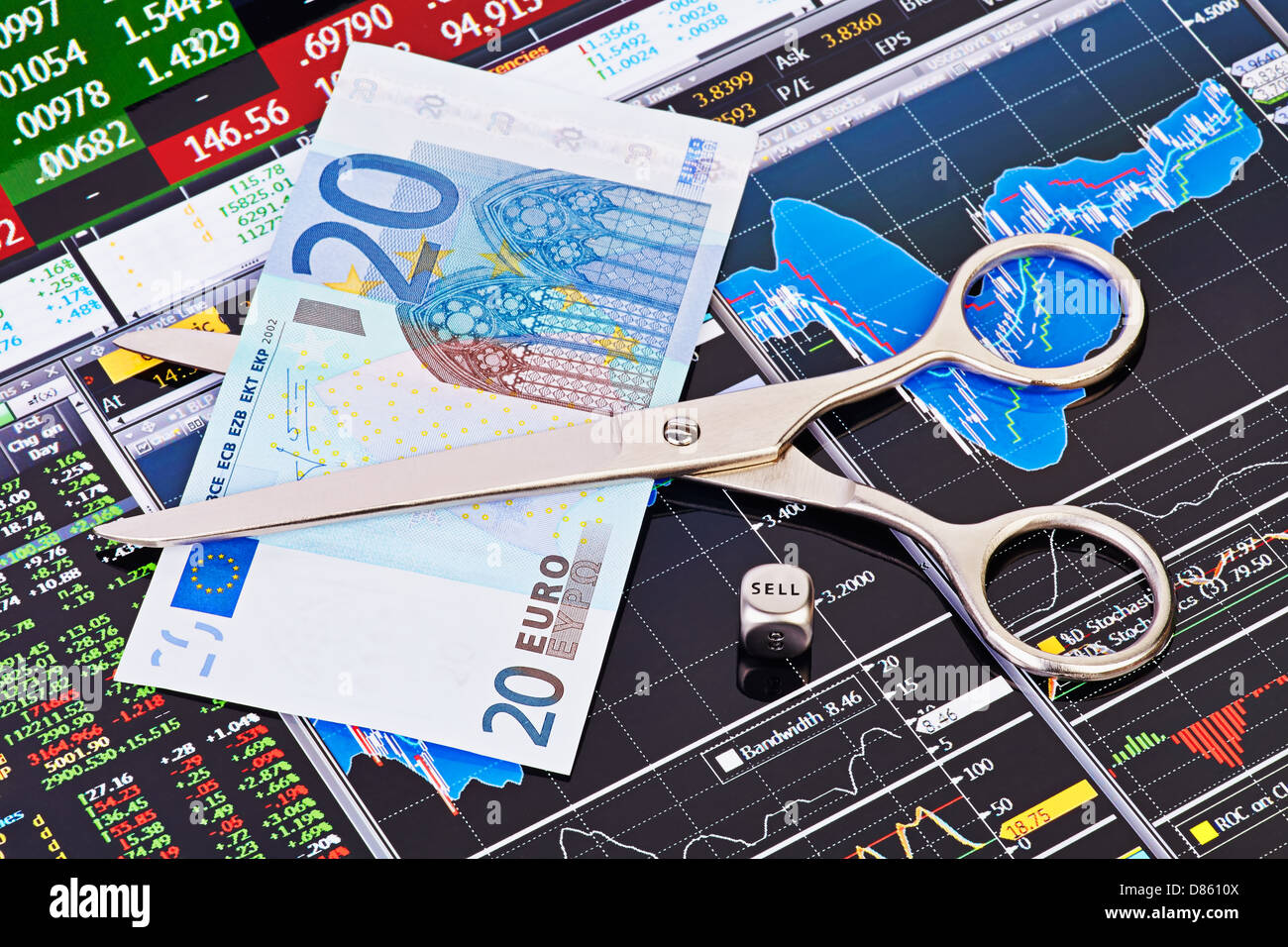 Scissors cutting euro banknote, dices cube with the word SELL. Financial charts and columns of prices as background Stock Photo
