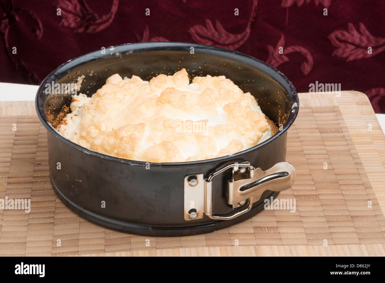 Meringue cake in a springform pan on a wooden board Stock Photo Alamy