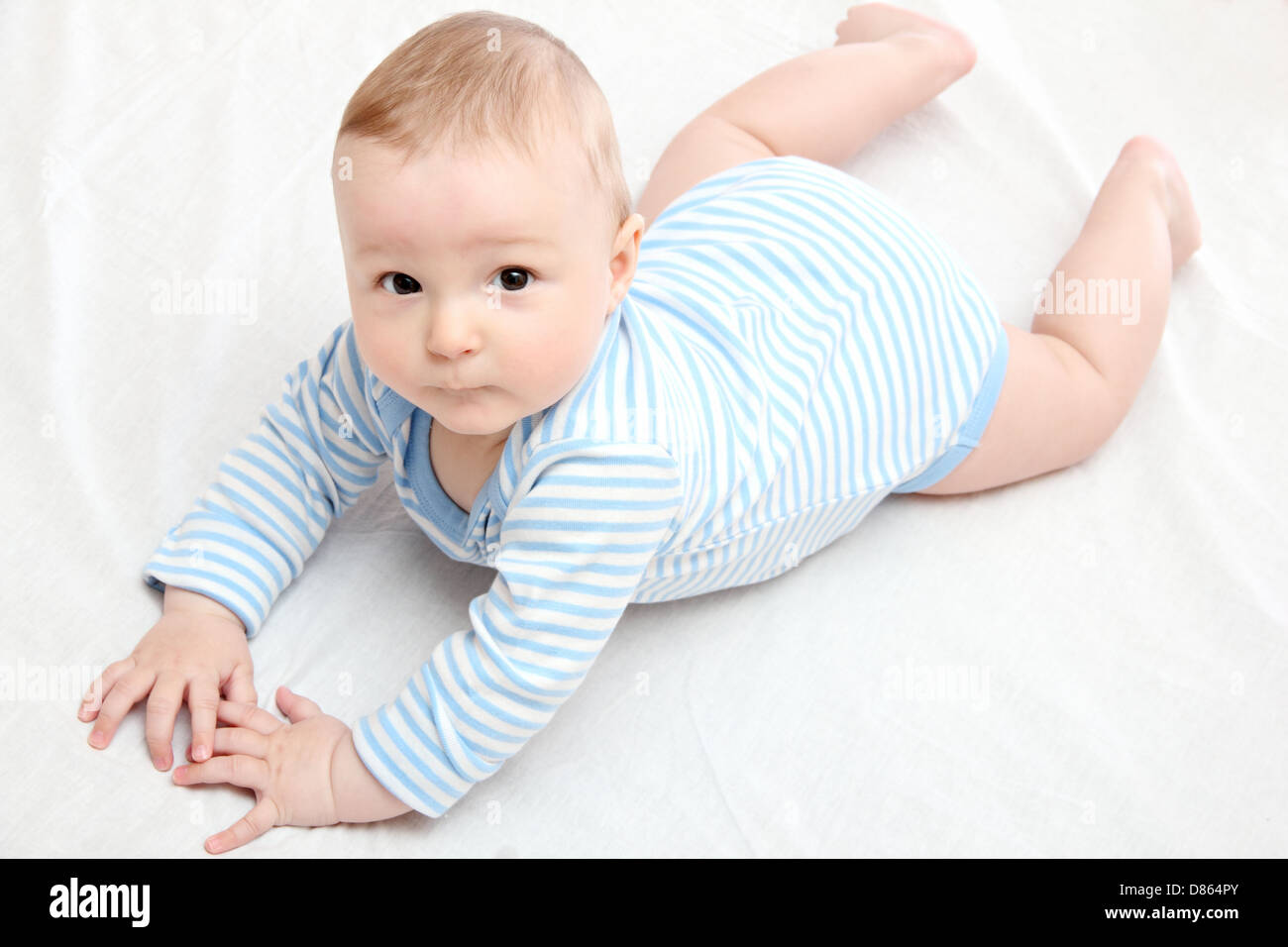 Baby boy lies on bed Stock Photo
