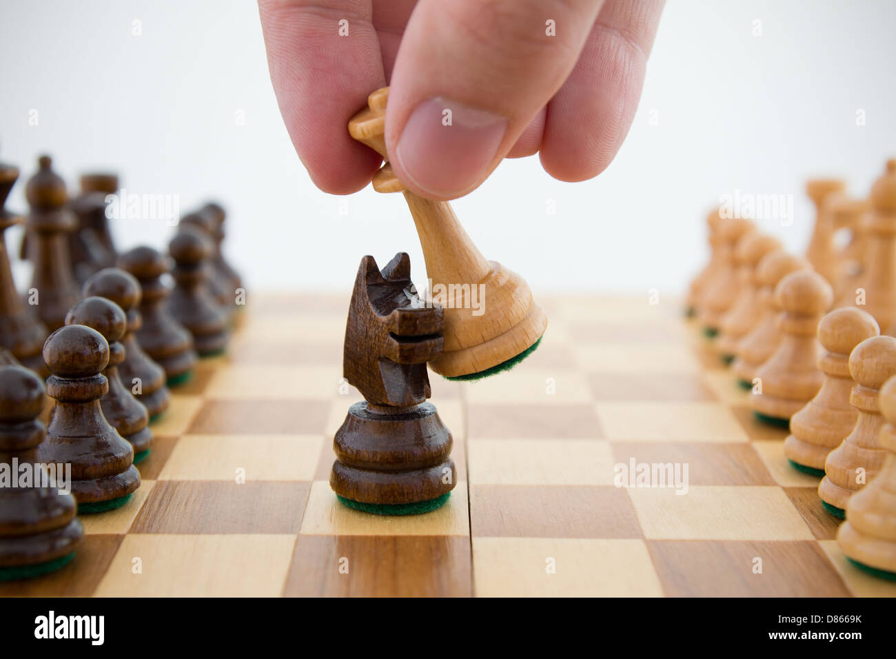 Chess game. Queen captures horse Stock Photo Alamy