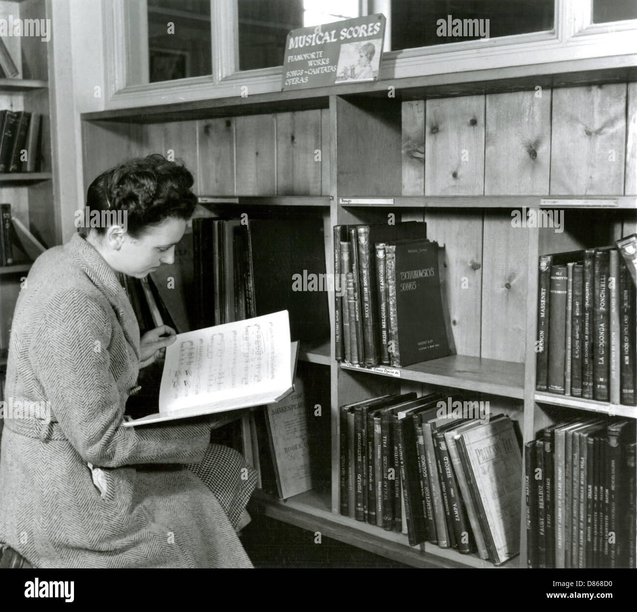 Reading A Score In A Music Library Stock Photo