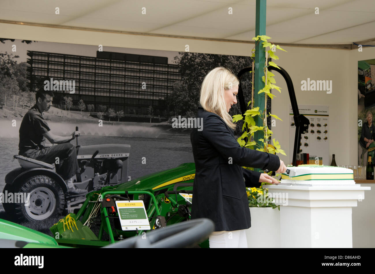 Zara Phillips cuts the cake to celebrate 50 years of John Deere at RHS Chelsea Flower Show, London, UK on Press day 20th May 2013. John Deere began producing lawnmowers and garden tractors in 1963. Stock Photo