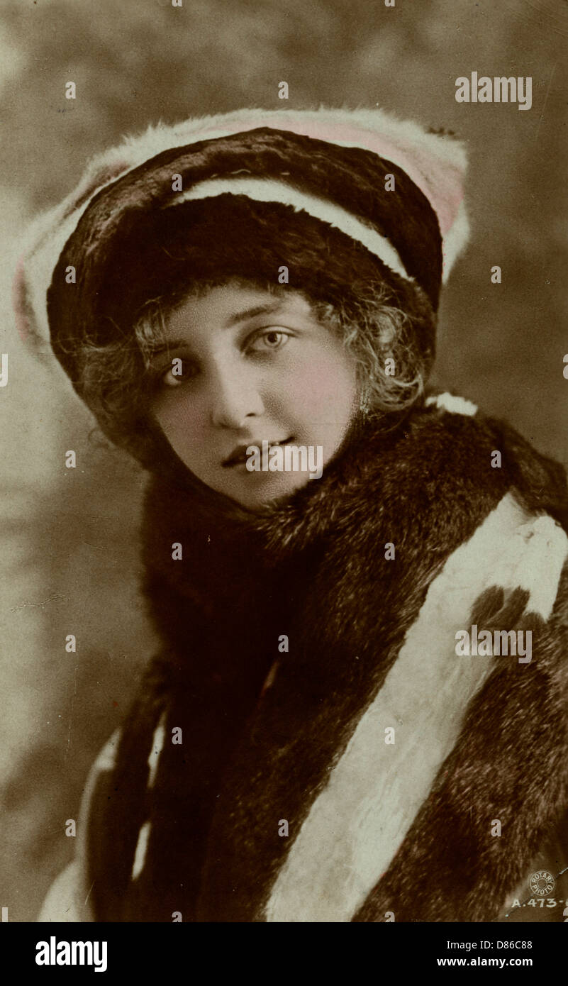 Pretty young woman in fur coat and hat Stock Photo