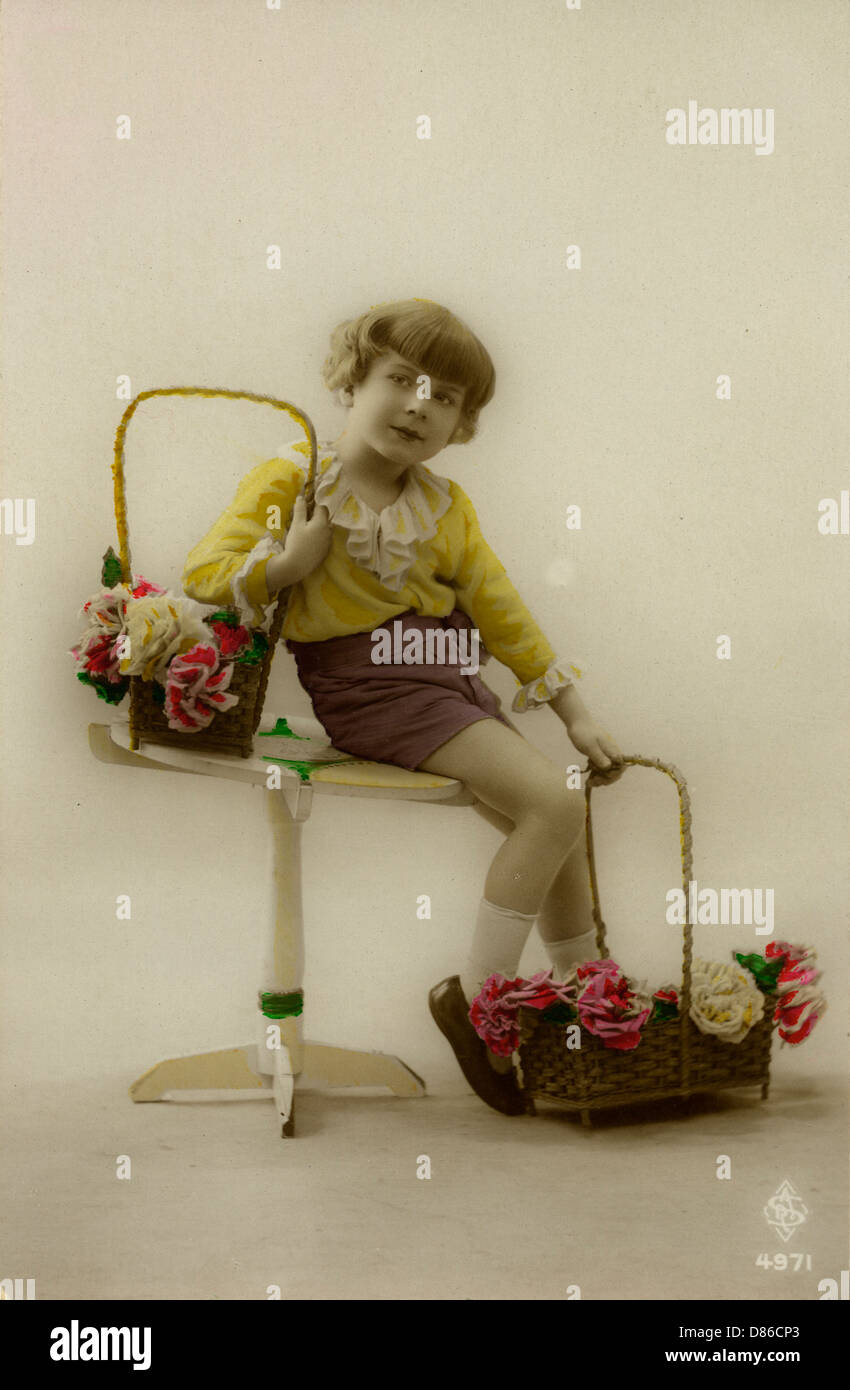 Little girl on a postcard with baskets of flowers Stock Photo
