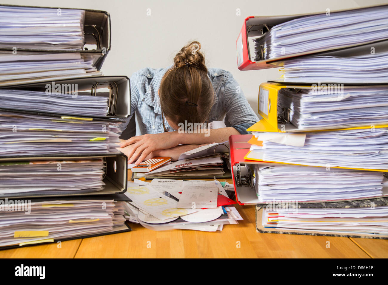 Young woman is sitting at home and sort out bills, receipts and other papers for her tax declaration. Stock Photo