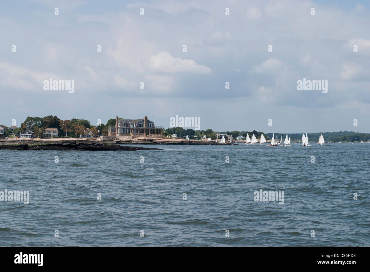 Homes are built close to the water on the rocky island shore in Long Island Sound, Connecticut USA. Stock Photo