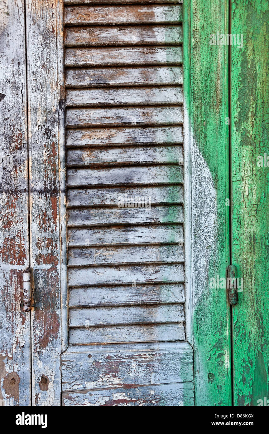 Vintage wooden window shutter with smudged paint background texture. Stock Photo