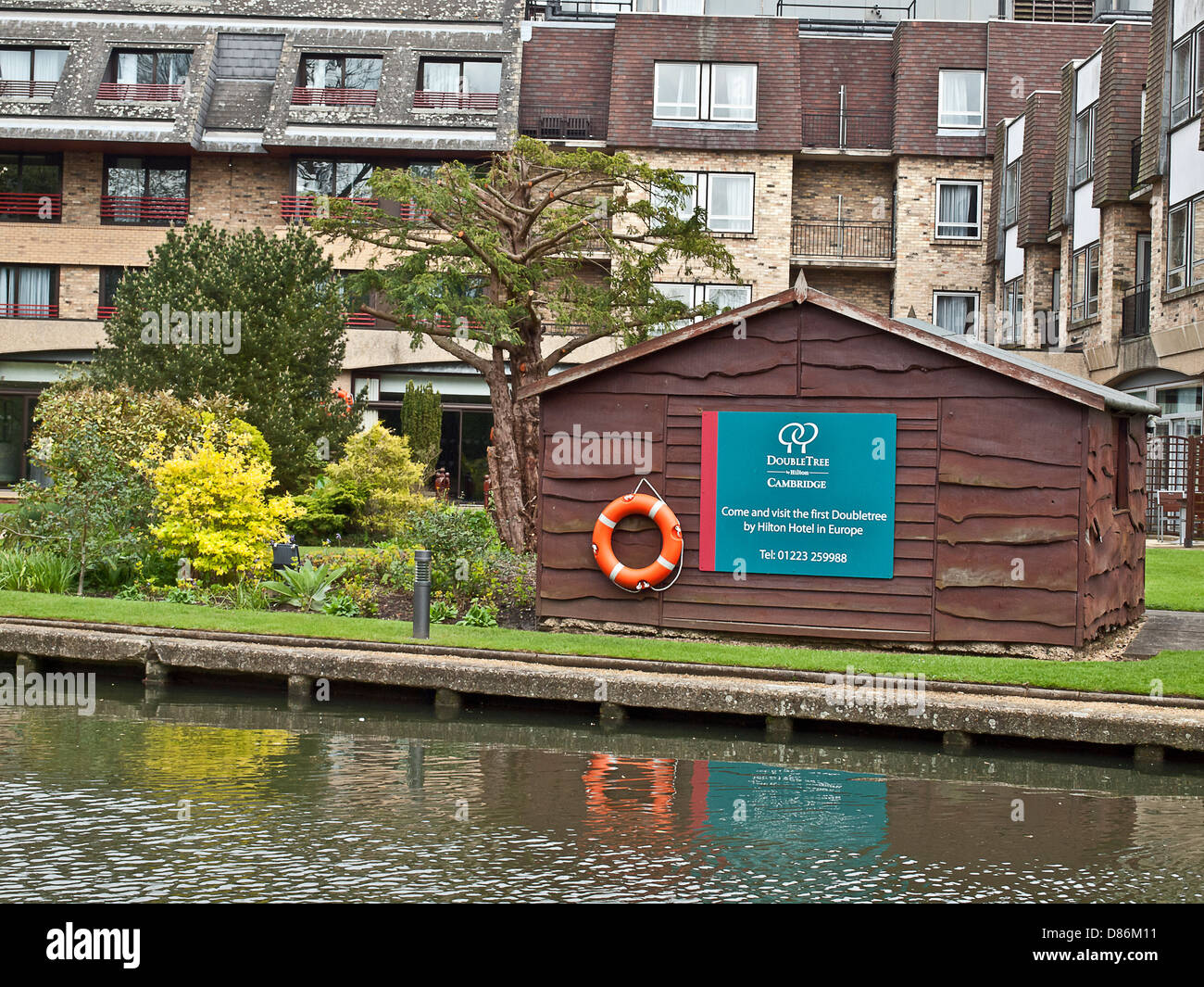 A Life buoy next to the river Cam in people housing estate in Cambridge, UK Stock Photo