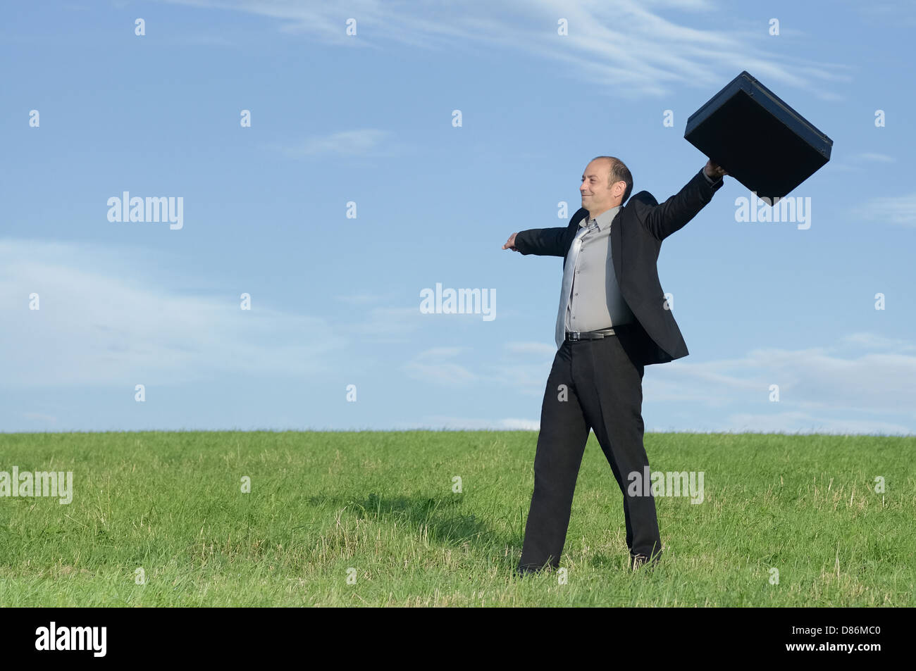 Businessman in tranquil nature scene enjoying freedom of success Stock Photo