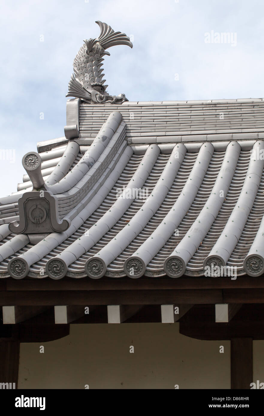 Japanese castle roof tiles against blue sky Stock Photo