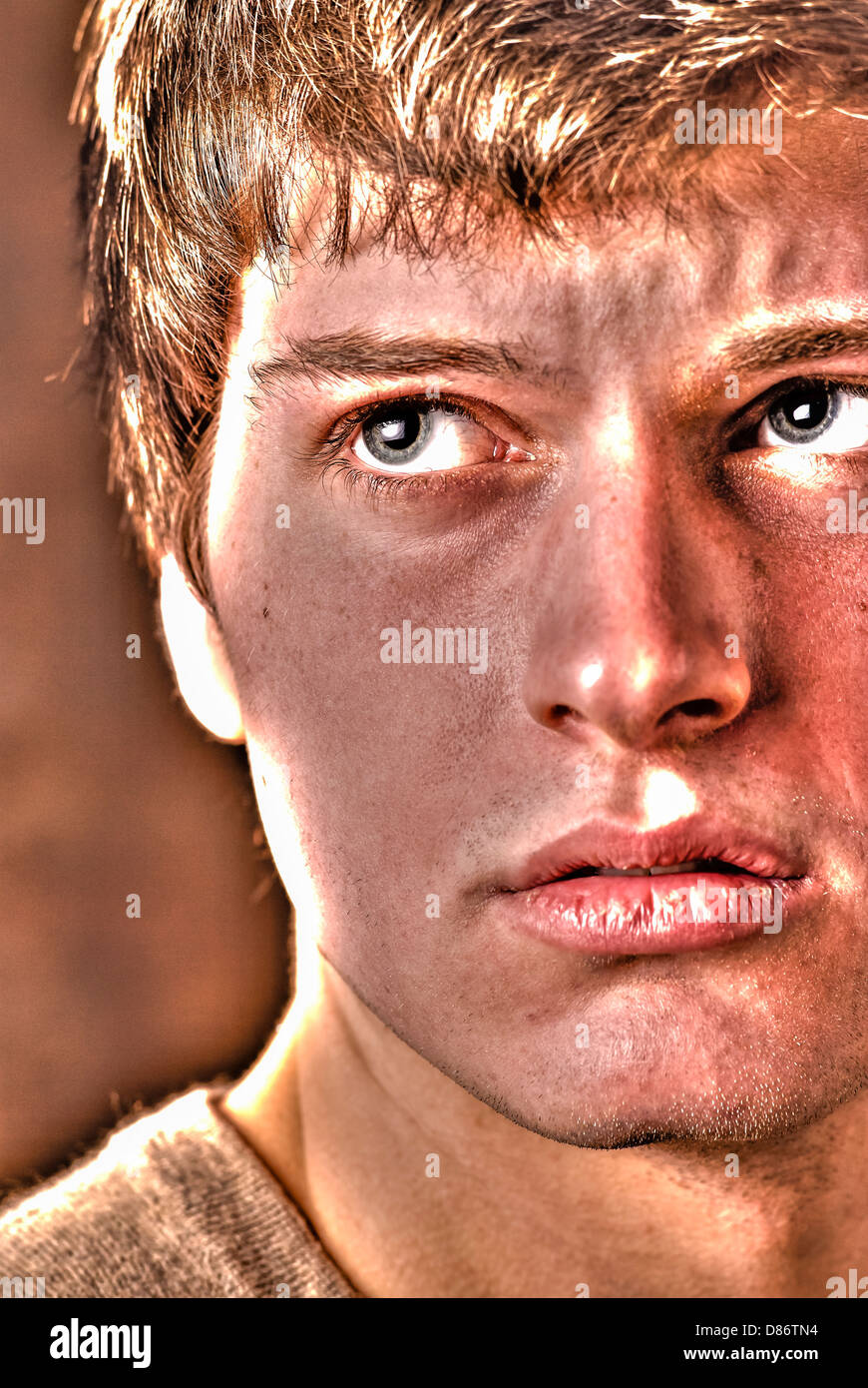 Teen male somewhat sad or depressed in a studio environment. Stock Photo