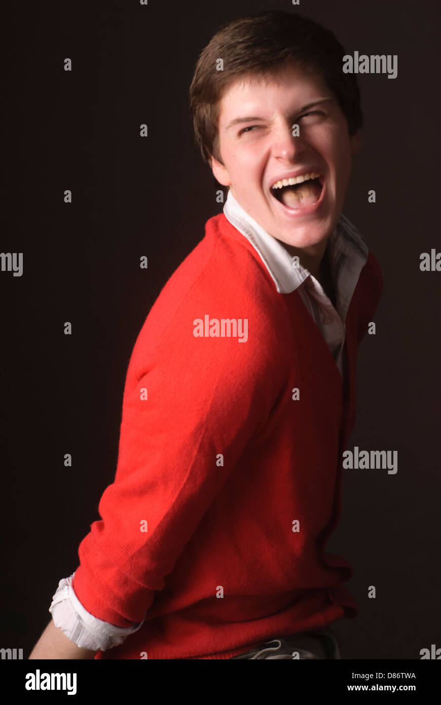 Young man posing and cutting up in studio environment Stock Photo Alamy