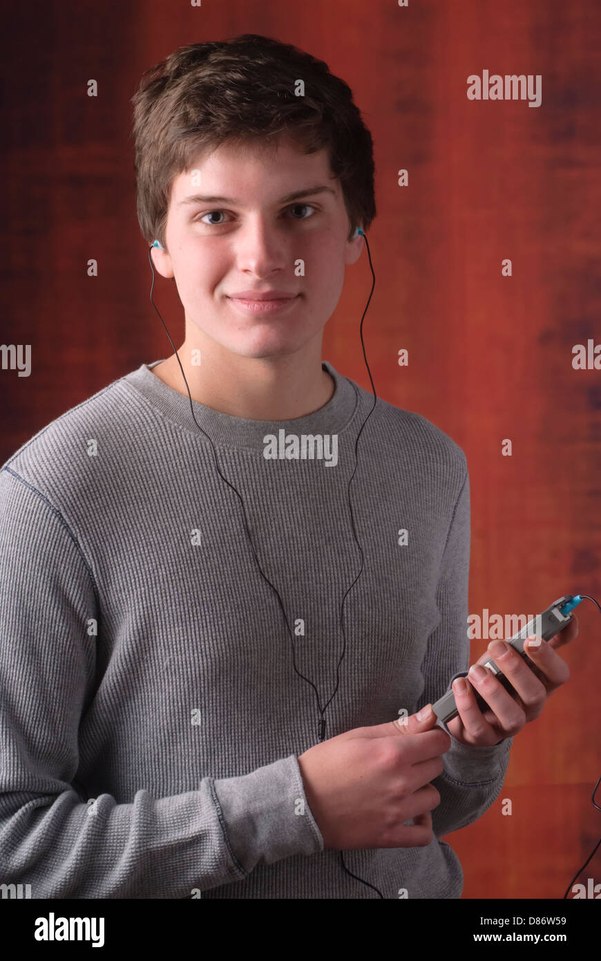 Young male listening to music on an iphone Stock Photo