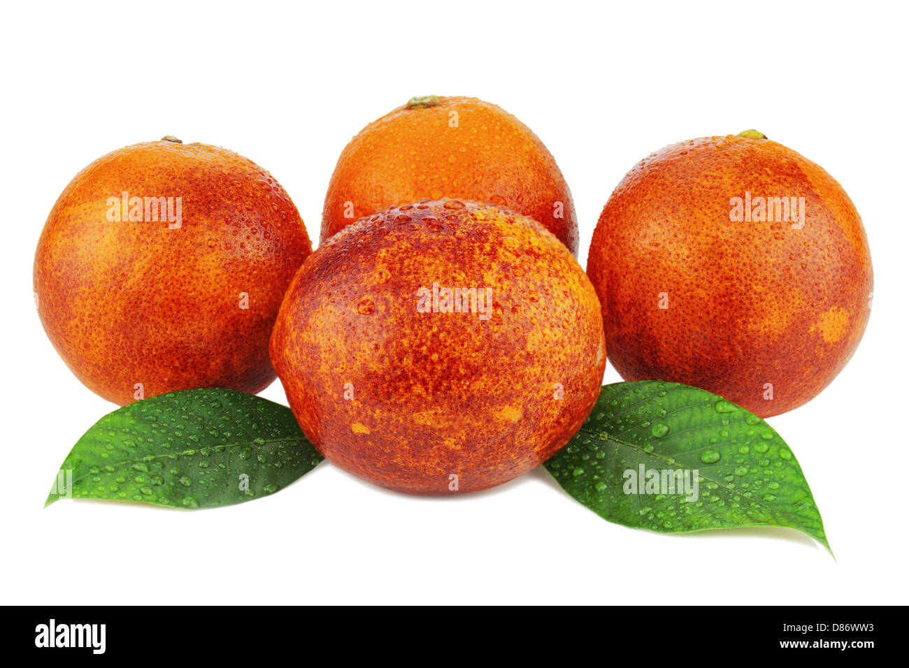 Ripe red blood oranges with green leaves isolated on white background. Stock Photo