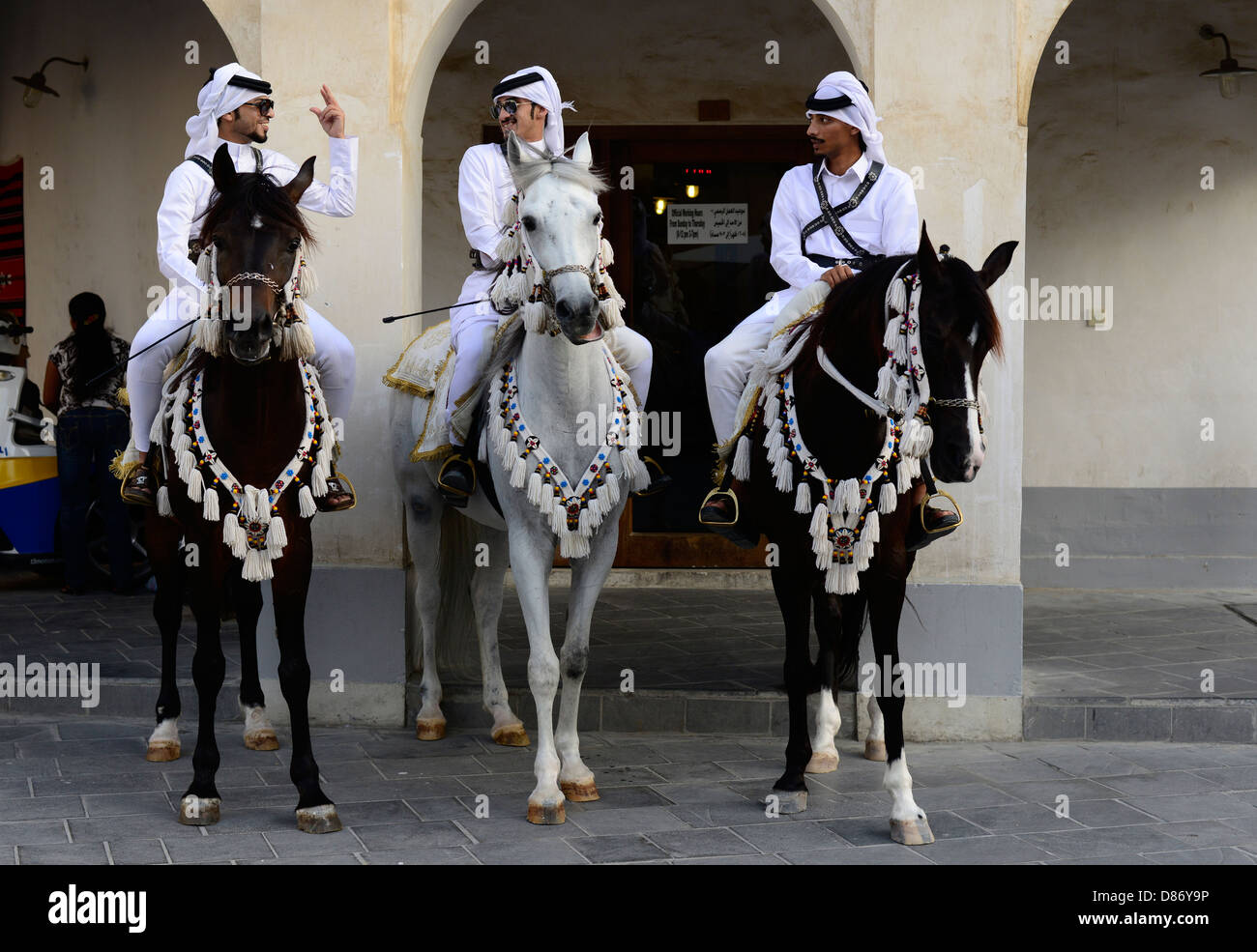 Proud Arab horsemen riding their beautiful Arabian horses in the old souk Waqif in Doha Stock
