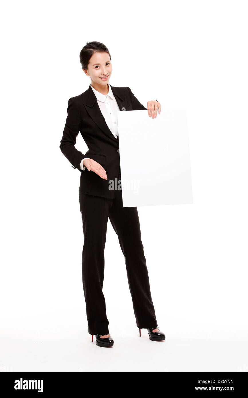 young businesswoman posing in studio blank piece paper. Stock Photo