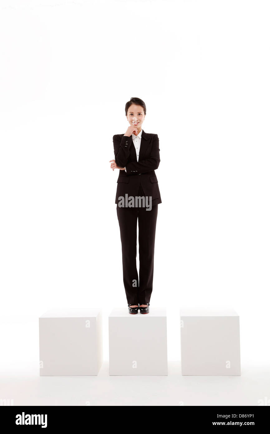 young businesswoman standing on box. Stock Photo