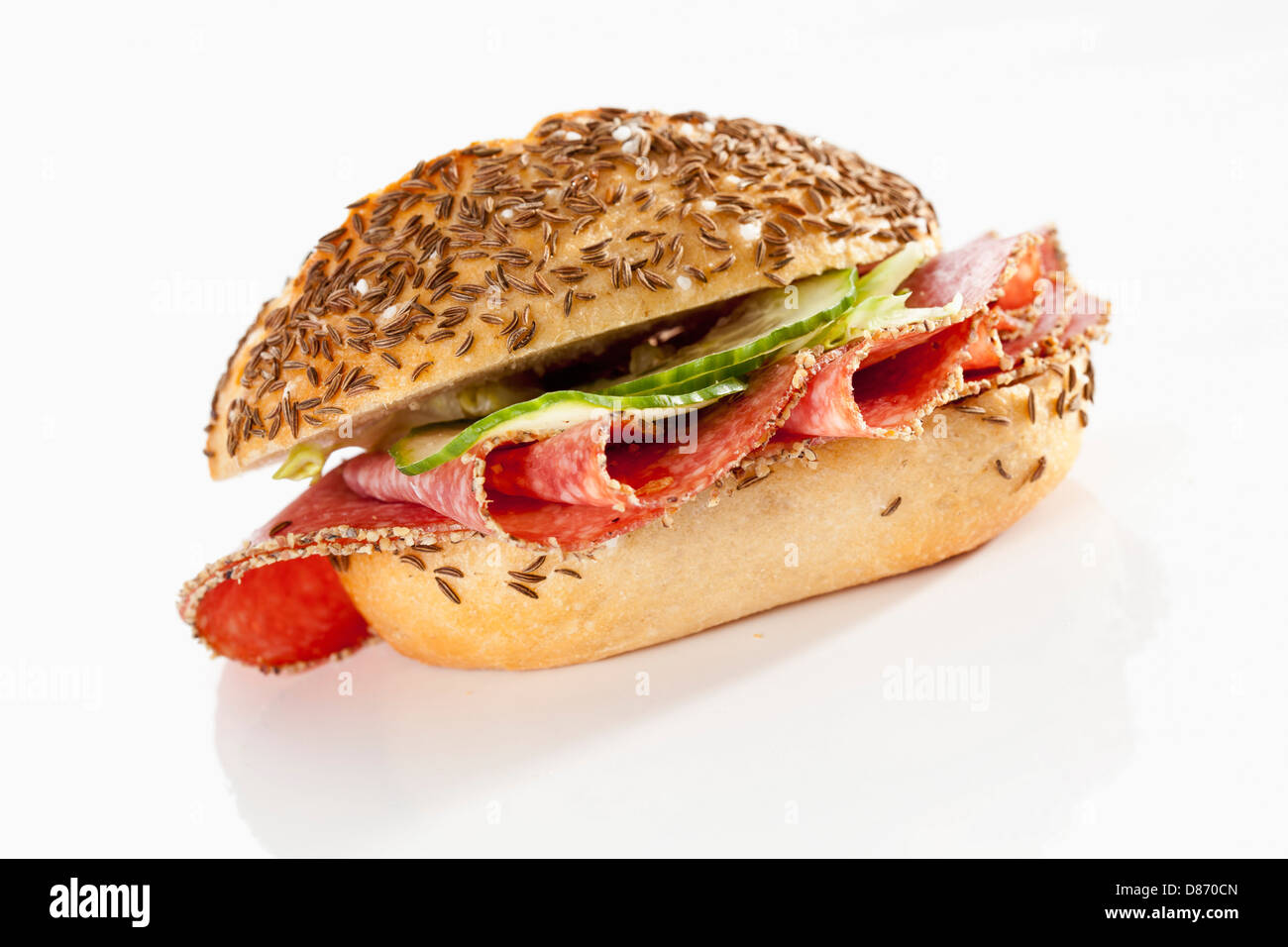 Sandwich of caraway seed bread roll with pepper salami on white