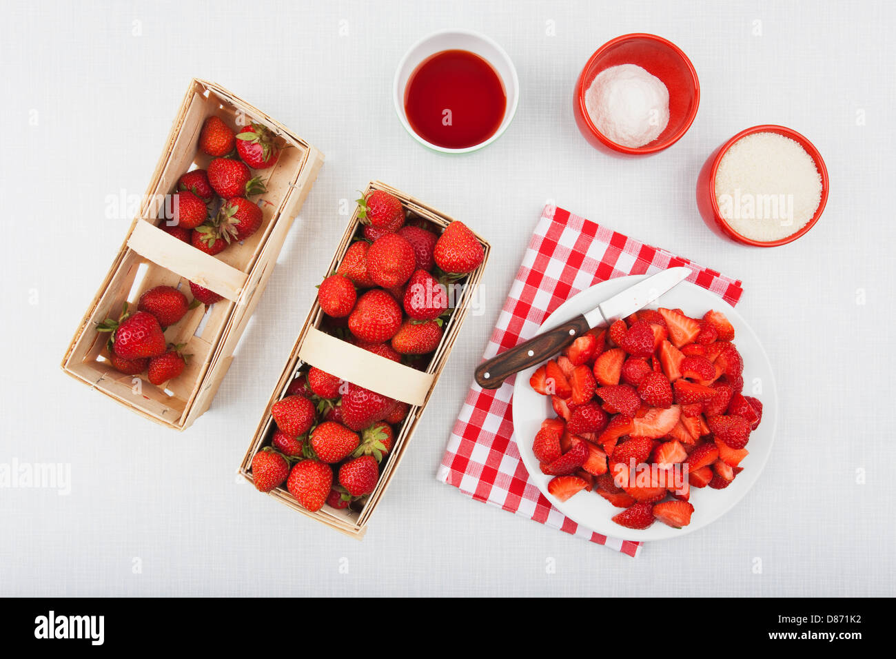 Cane sugar and pectin for strawberry jam with fresh strawberries in wooden basket Stock Photo