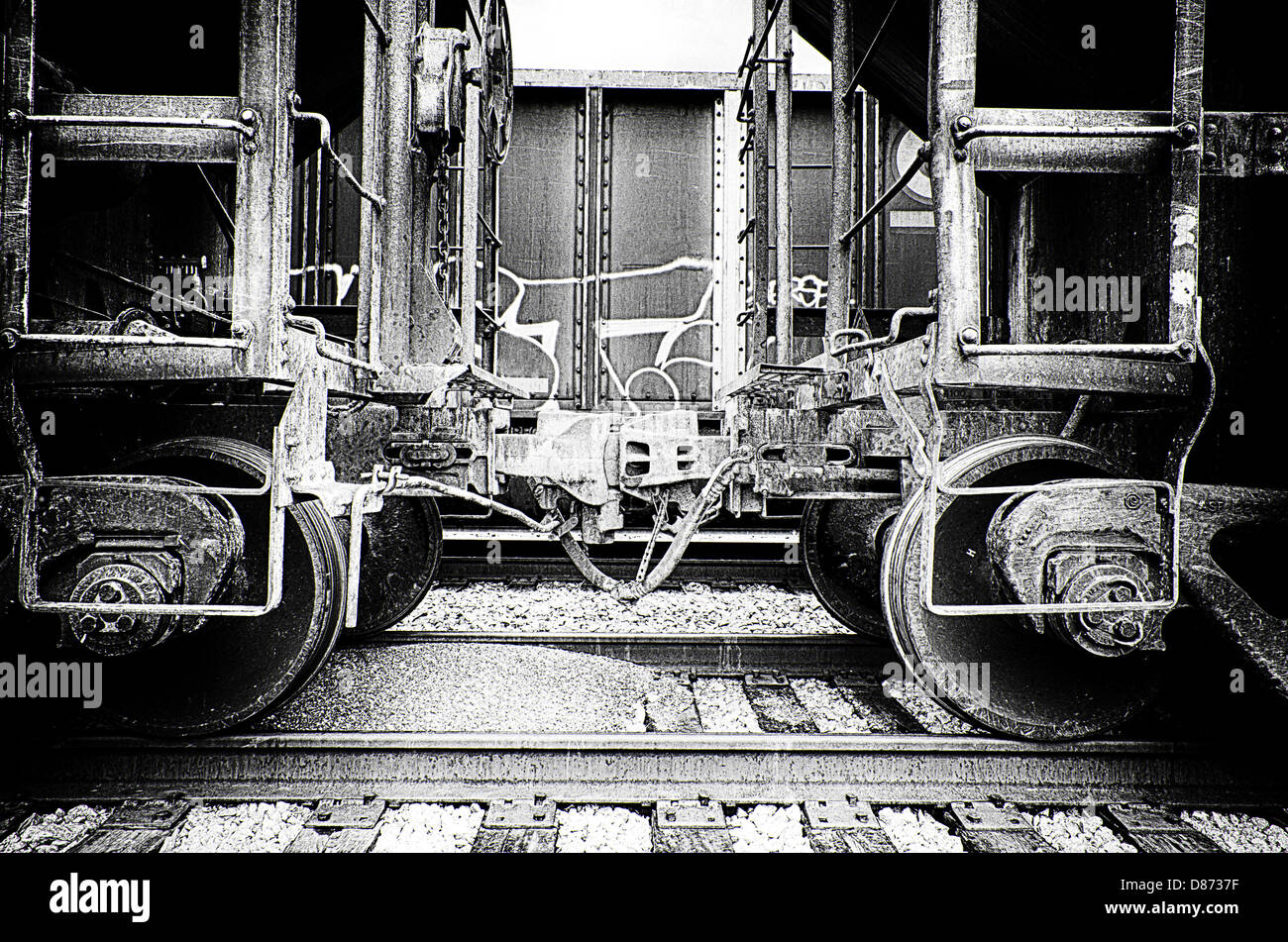 This is a black and white closeup image of train cars coupling. Stock Photo