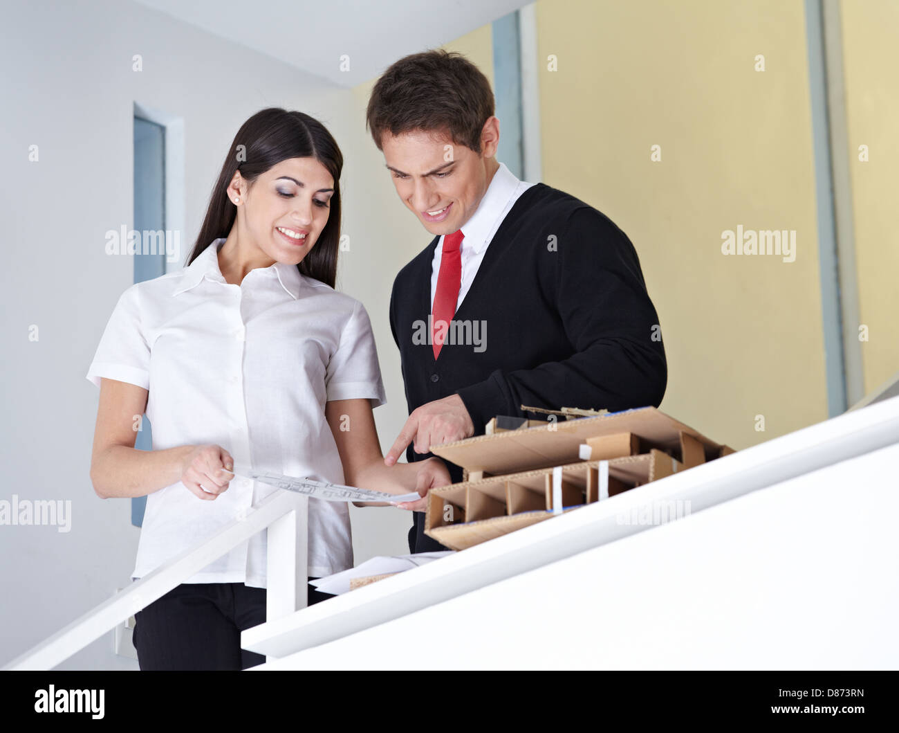 Two architects in the office discussing a construction drawing Stock Photo