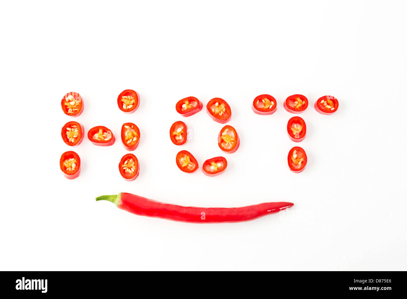 Red chilli peppers arranged in shape of word Hot, close up Stock Photo