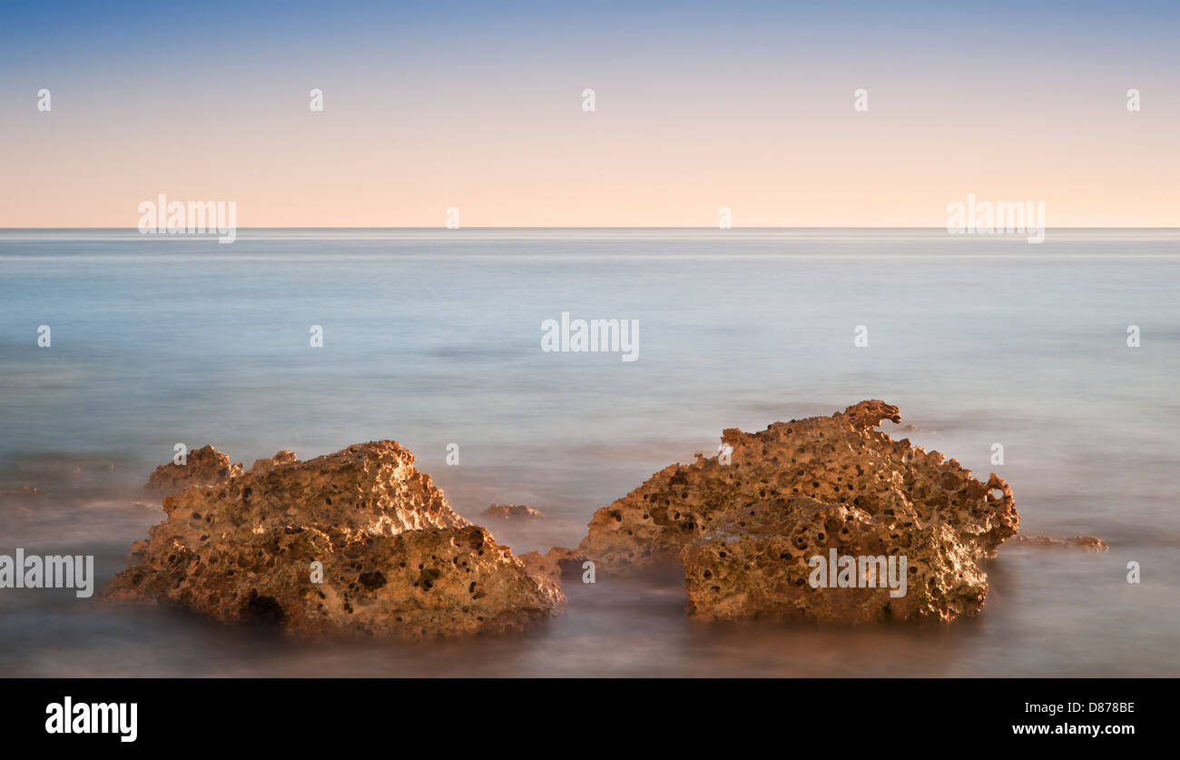 Stunning Summer sunset over ocean with rocks and vibrant colors Stock ...