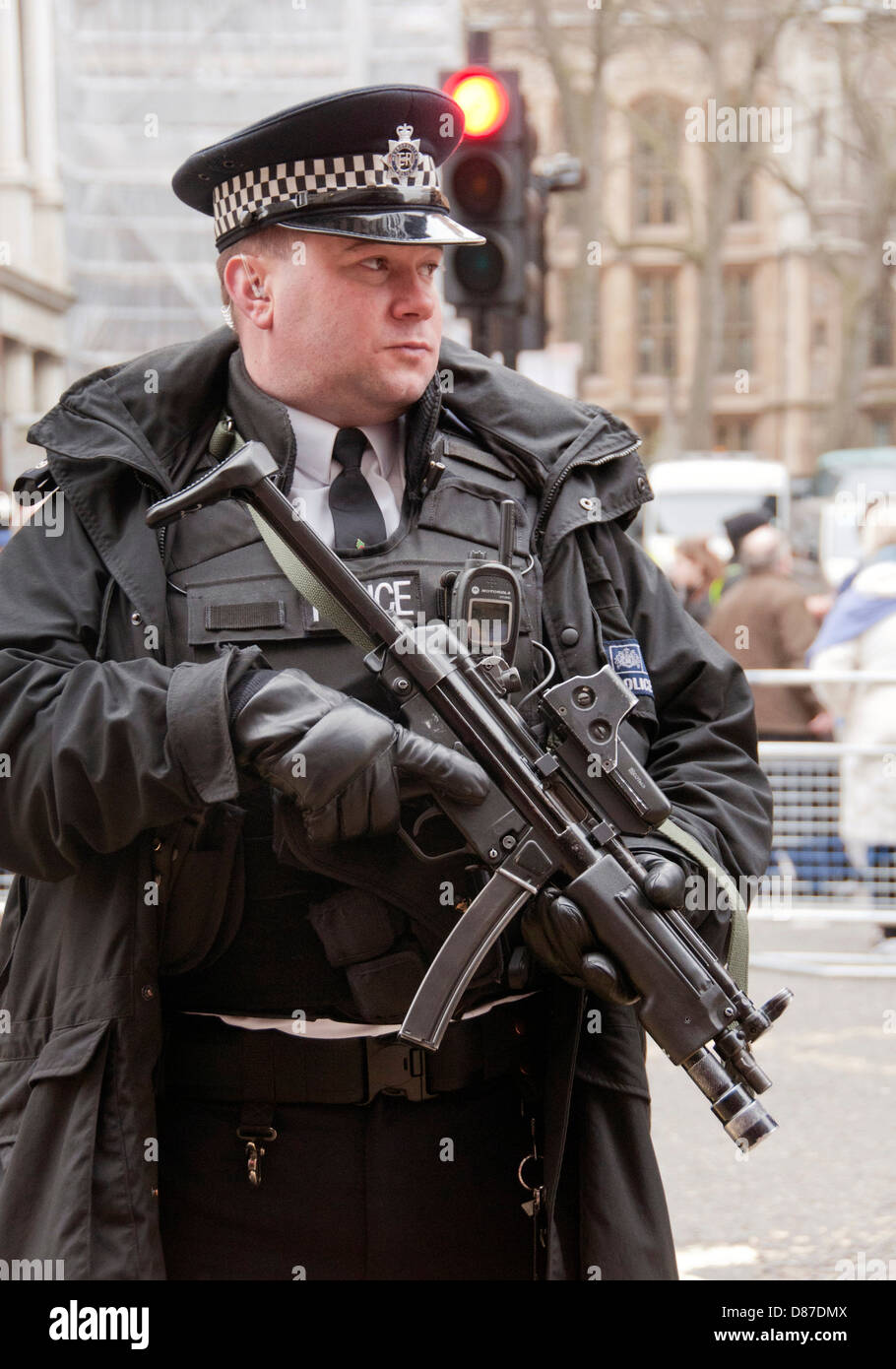 Armed police officer  with submachine gun in London Stock Photo