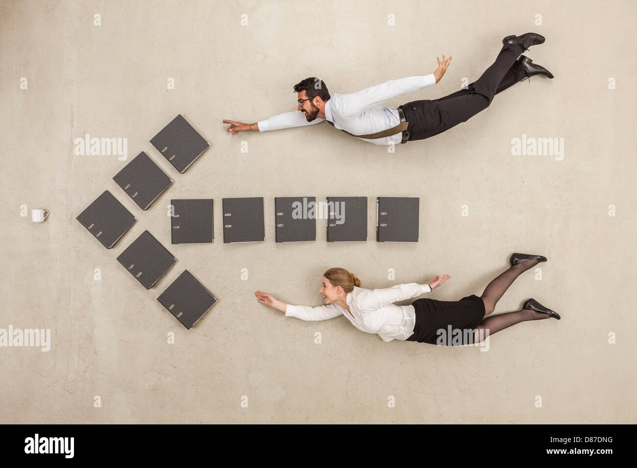 Business people flying along arrow sign formed by files Stock Photo - Alamy