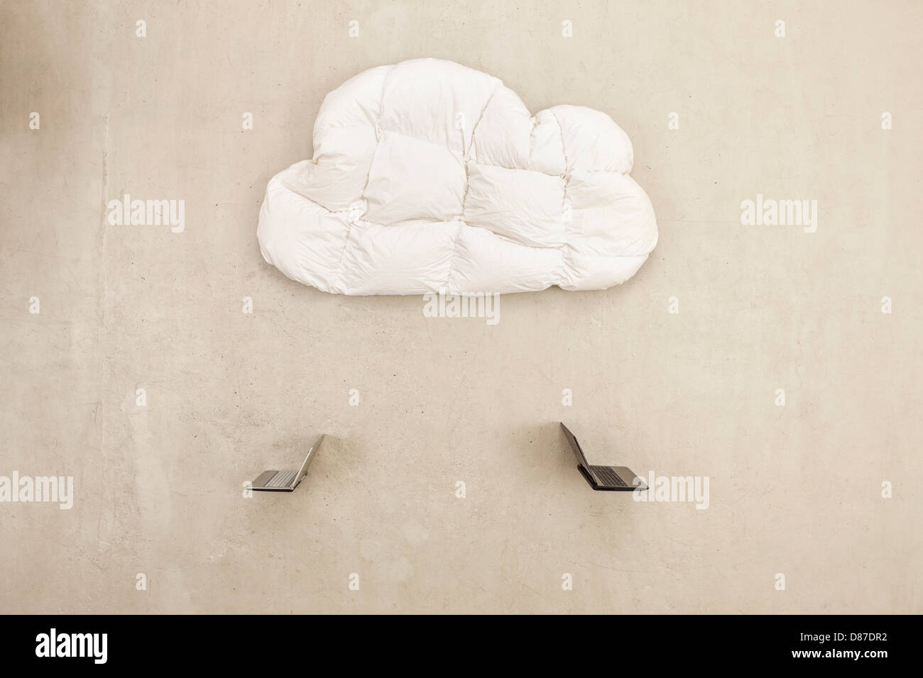 Two laptops below cloud shape pillow Stock Photo Alamy